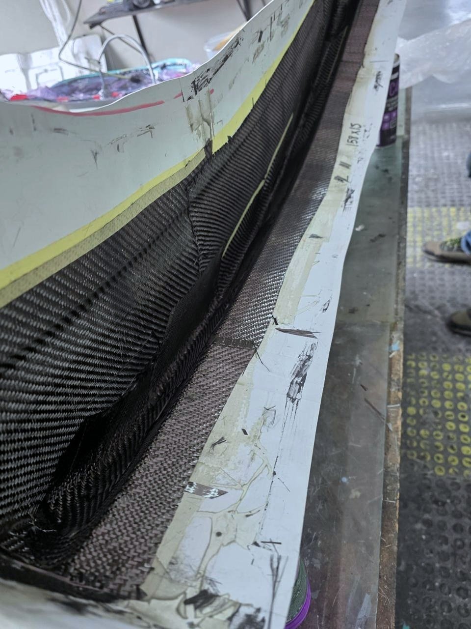 Carbon-fibre twill cloth laid by hand into the grille mould.