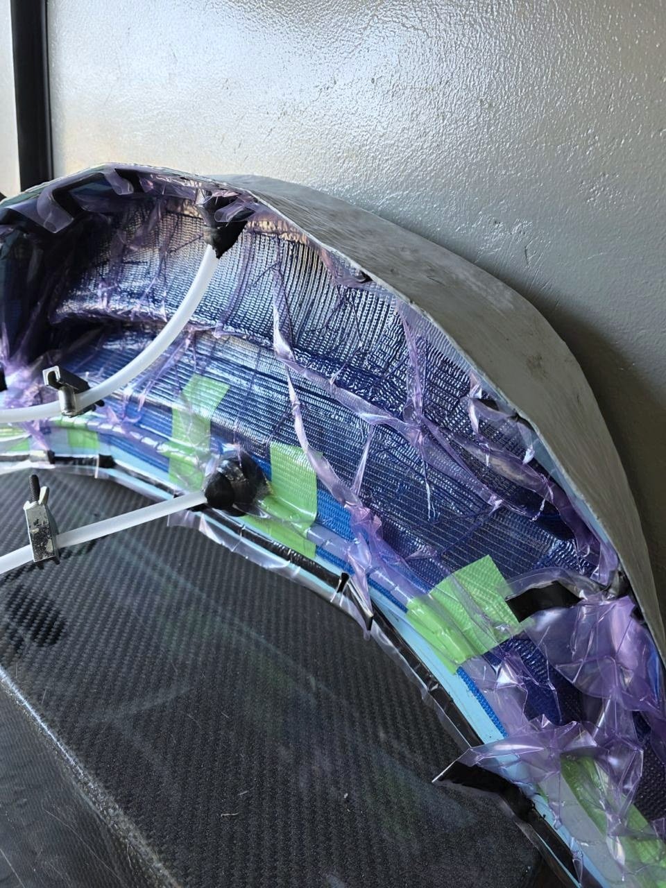 The vacuum bag drawn tight against the layup once the air is pulled out.